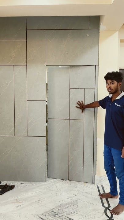 Seamless Concealed Passage Door within Grey Marble Wall Panelling