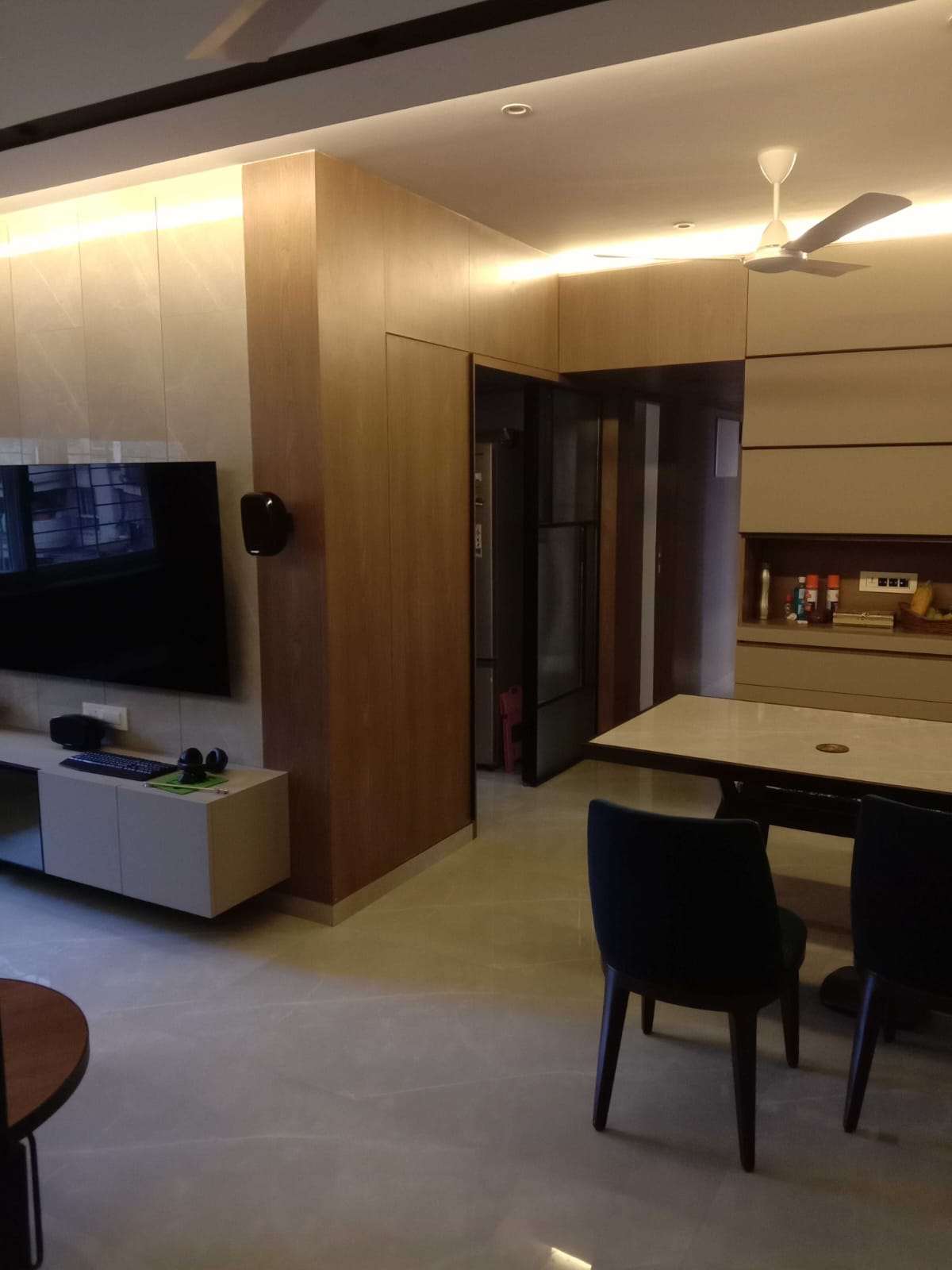 Open Concept Living & Dining with Marble TV Backdrop & Partition